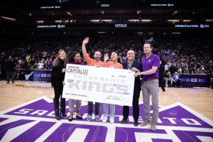 Photo announcing Shared Vision as the Sacramento Kings 2023 Capitalize Technology Winner for Affiliate Marketing SaaS with check given at halftime on court