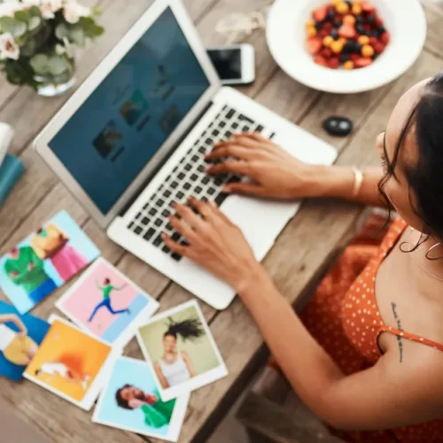 Photo of woman on laptop and full desk for the title image of "6 affiliate posts you need to use."