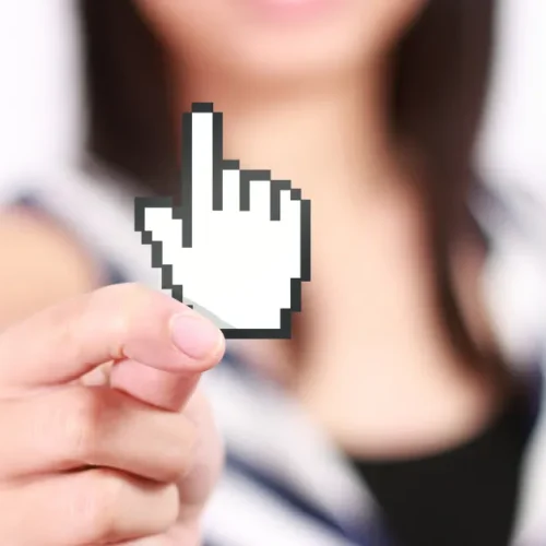 Photo of woman holding a click icon up to the center of the photo.